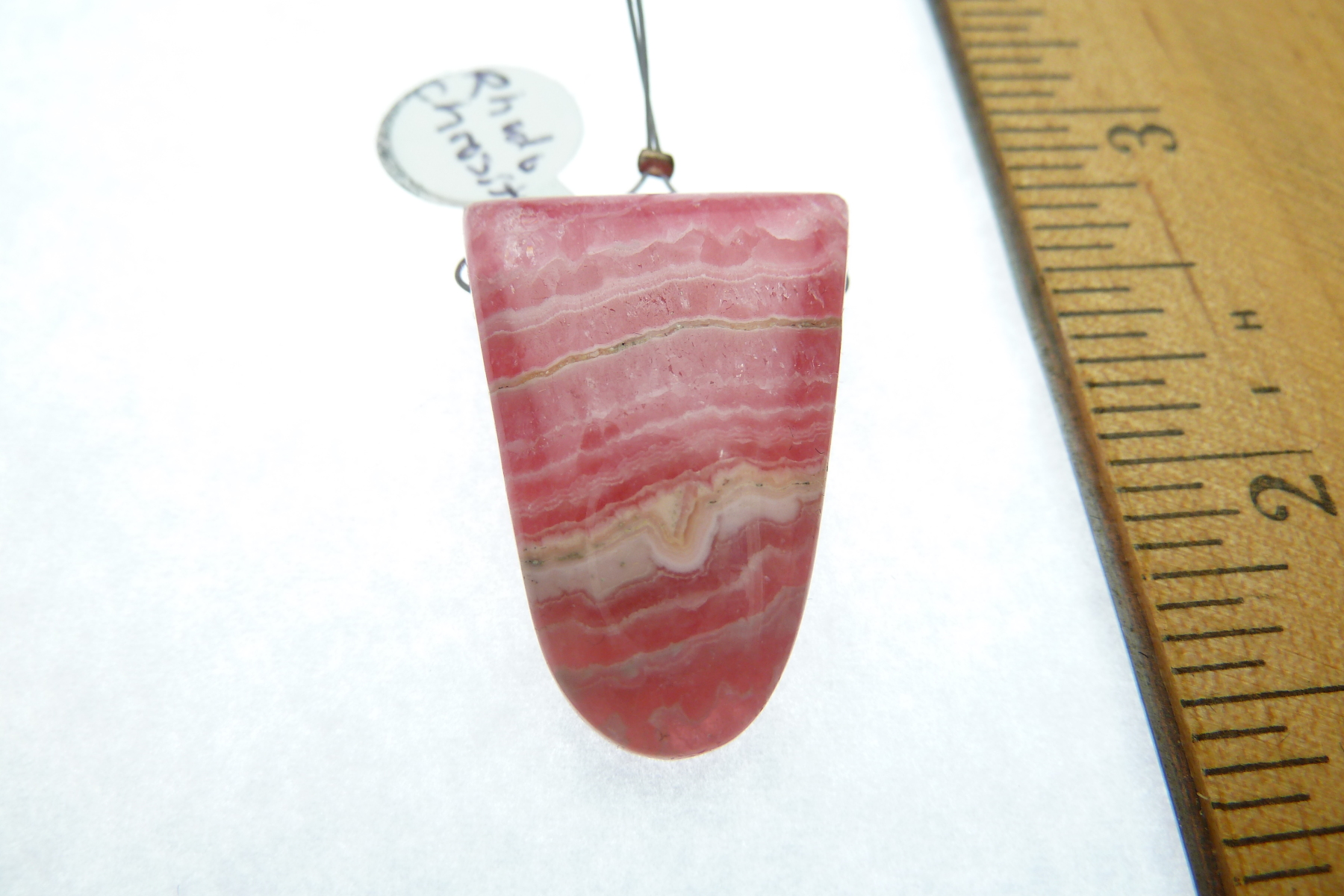 Scaled image P1010994.JPG: Item #Rhodo1, Price $50.00 Rhodochrosite pendant drop bead. Simple bead cut drilled at the widest part of the bead. Bead is 29mm long by 20mm wide. Bead is drilled at the widest part of the stone and drill hole size is about 2.0 mm.� 