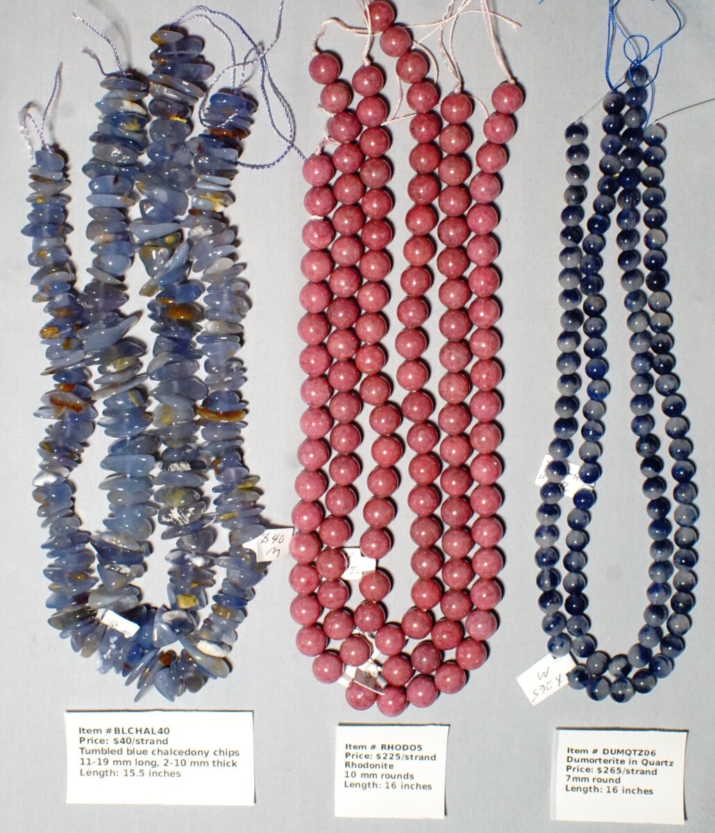 Scaled image CHAL-RHODO-DUMOR.JPG: Item # BLCHAL40-Blue Chalcendony chips, $40/strand
Item # RHODO5-10 mm Rhodonite round, $225/strand
Item # DUMQTZ06-Dumorterite in Quartz, 6 mm, $265/strand� 