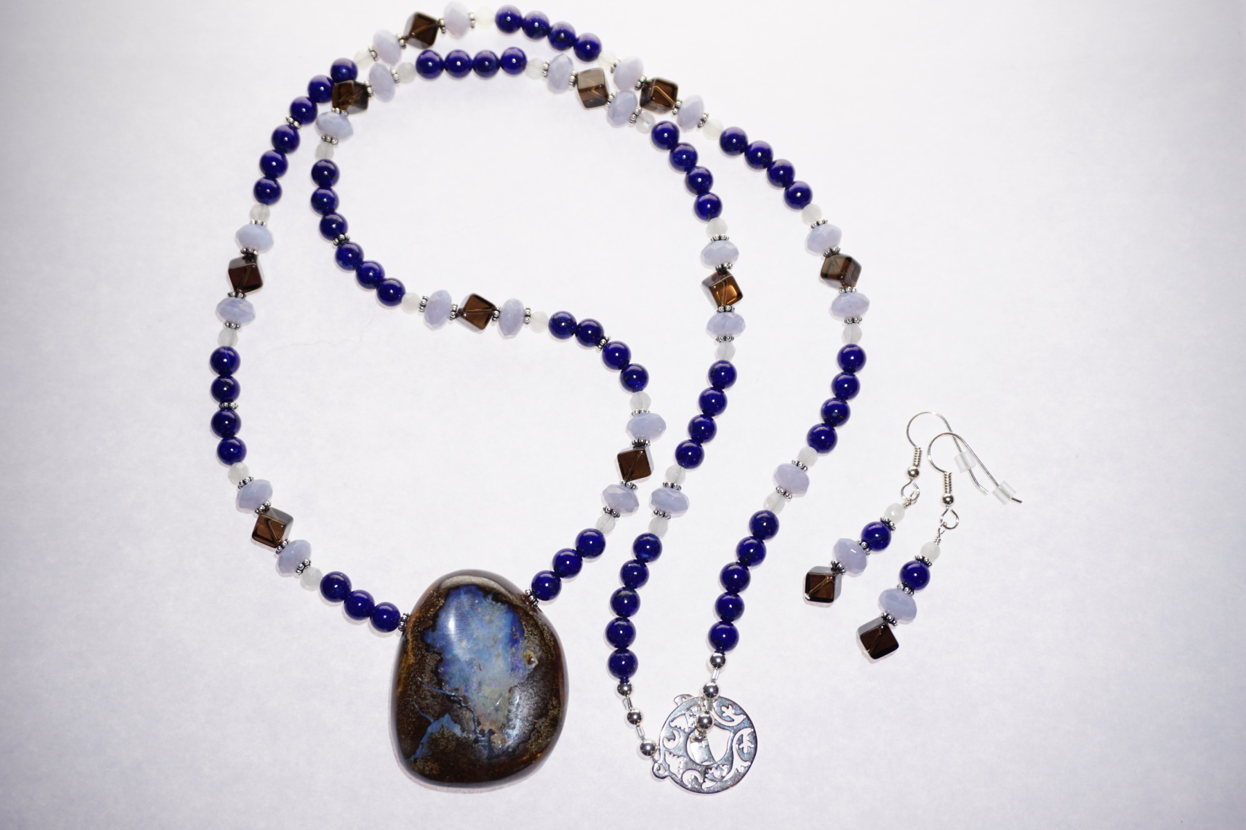 Scaled image DSC00158.JPG: Bolder Opal drop, Lapis, Quartz, Blue Chalcedony, Smoky Quartz, Bali spacers, and Sterling Silver findings and clasp.� 