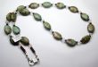 Thumbnail Greenopal.JPG: Item # 7201510, Green Opal ovals offset by pipestone and spiral cut clear quartz. $95.00 24 inch length. 